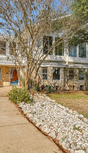 Home exterior with attached garage and garden in Texas