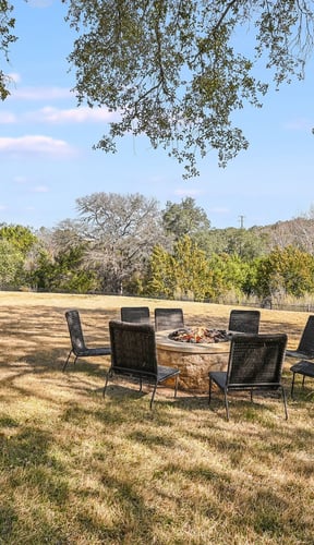 Spacious backyard with firepit and lush green grass