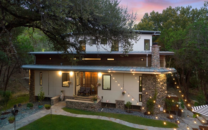 Home exterior with hanging lights on backyard