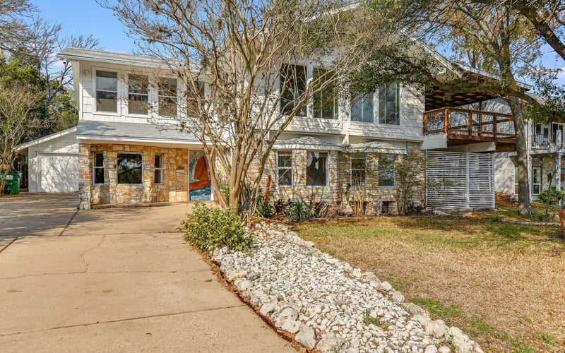 Home exterior, attached garage, and a lovely garden in Texas