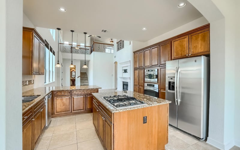 A kitchen with stainless steel appliances, including a refrigerator, stove, oven, and dishwasher.